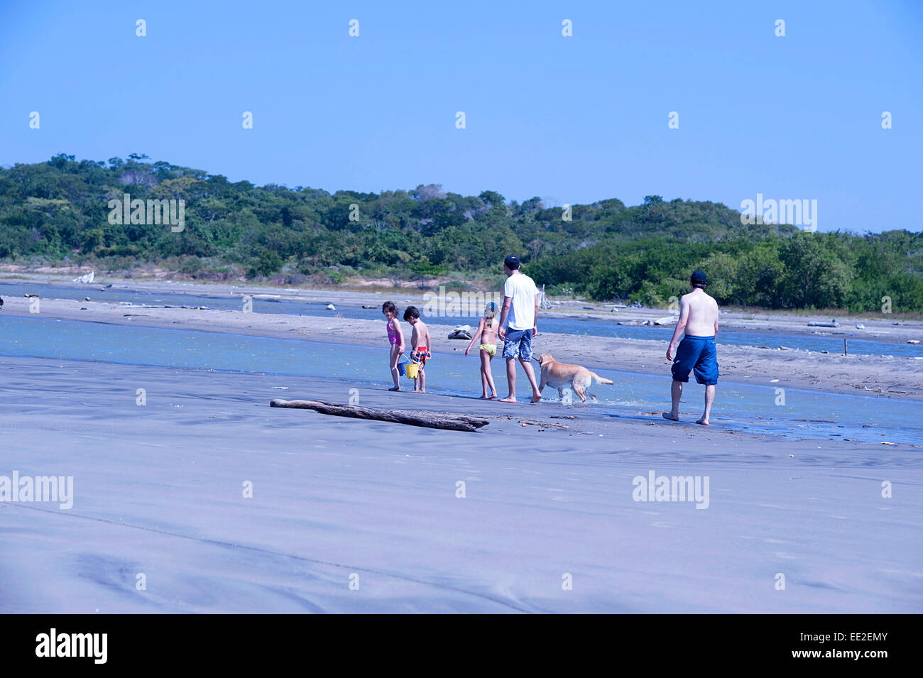 Family stroll along water's edge on empty sandy beaches. Outskirts of Cartagena, Colombia. Stock Photo