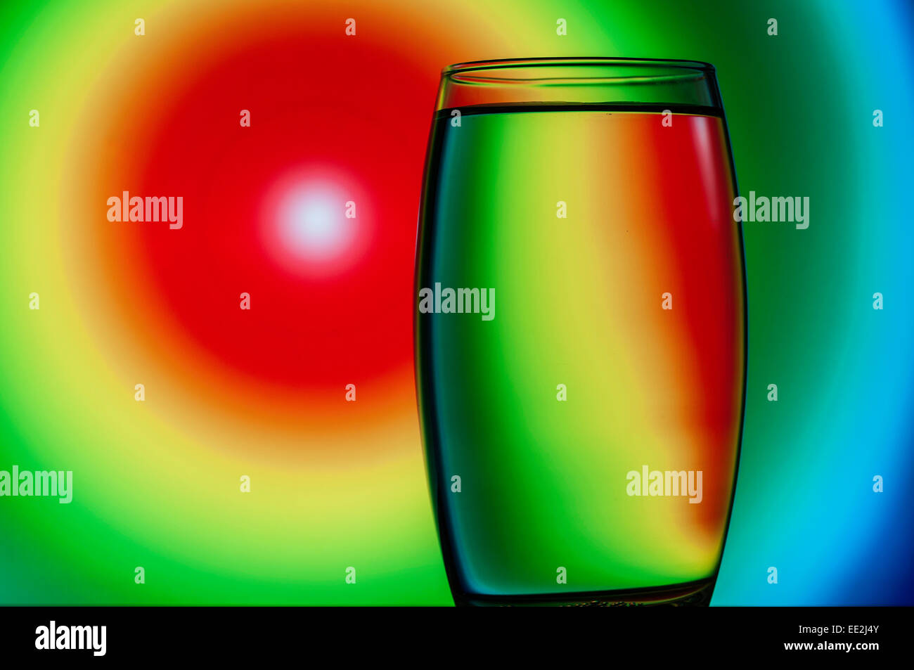 A tumbler of water against a patterned background to illustrate the