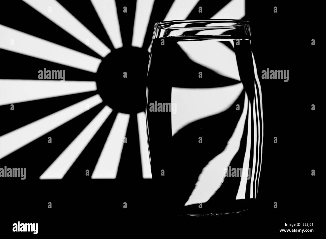 A tumbler of water against a patterned background to illustrate the