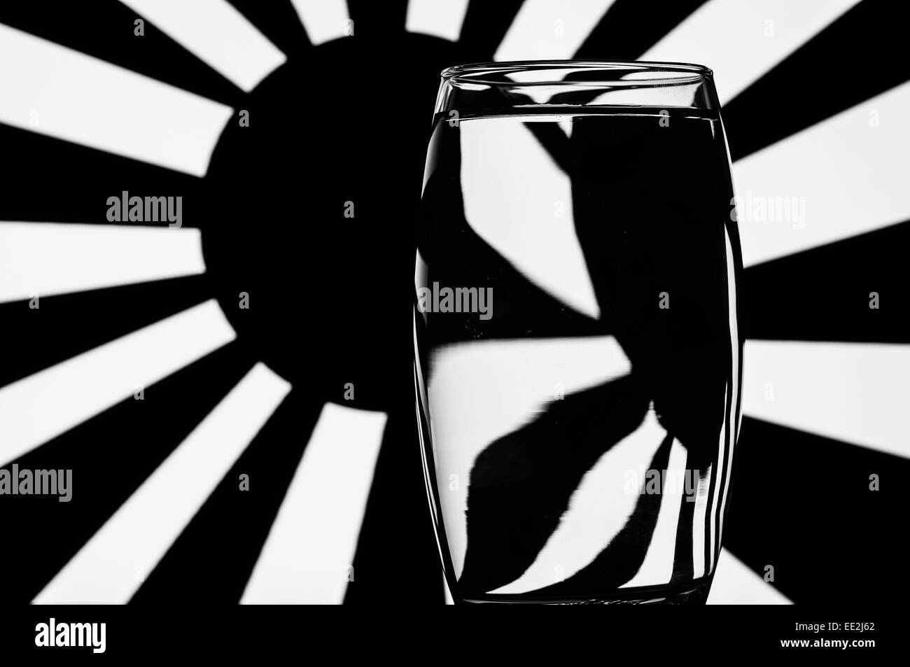 A tumbler of water against a patterned background to illustrate the