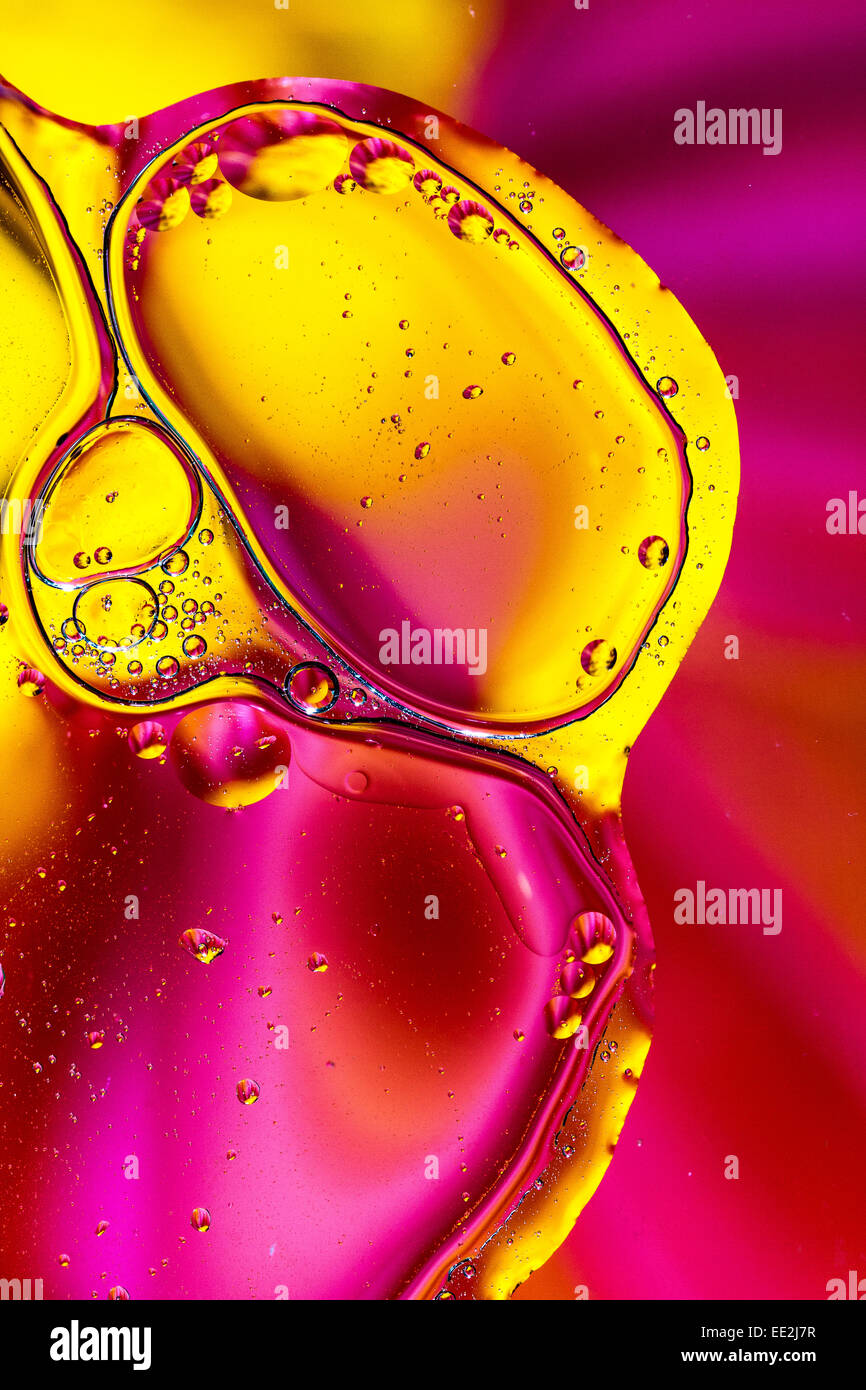 Abstract oil and water pattern.  Golden yellow and pink background shapes. Stock Photo