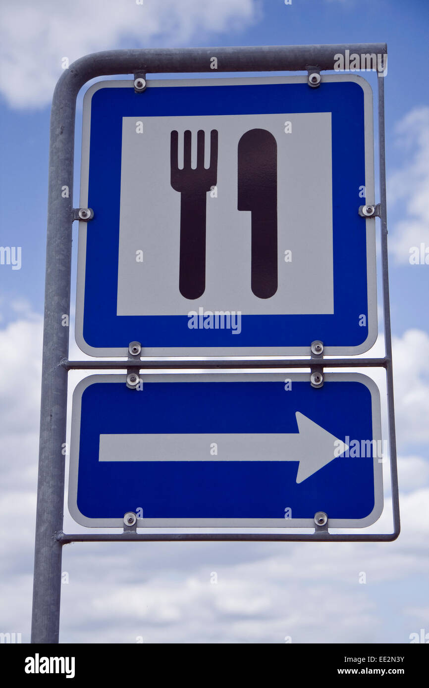 Sign showing the way to the nearest restaurant. Stock Photo