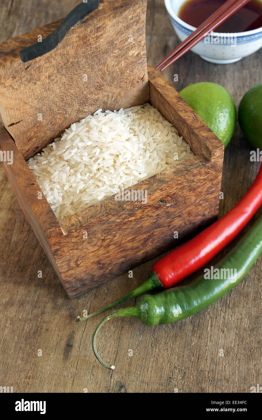Asian food ingredients rice, chili's and limes Stock Photo