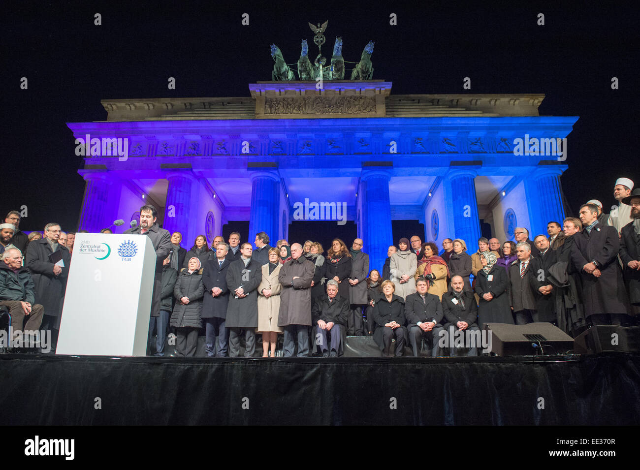 Berlin, Germany. 13th Jan, 2015. Chairman of the Central Committee of Muslims in Germany, Aiman Mazyek, speaks at a vigil for the victims of the attacks in France at the Brandenburg Gate in Berlin, Germany, 13 January 2015. The Central Committee of Muslims and the Turkish community have invoked the slogan 'Stand together - Show face' for the rally against Islamist terror and for the peaceful co-existence of the religions. Photo: MAURIZIO GAMBARINI/dpa/Alamy Live News Stock Photo