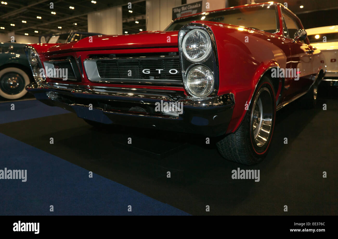 Low-Angle  view of a red 1960's Pontiac GTO at the London Classic Car Show. Stock Photo