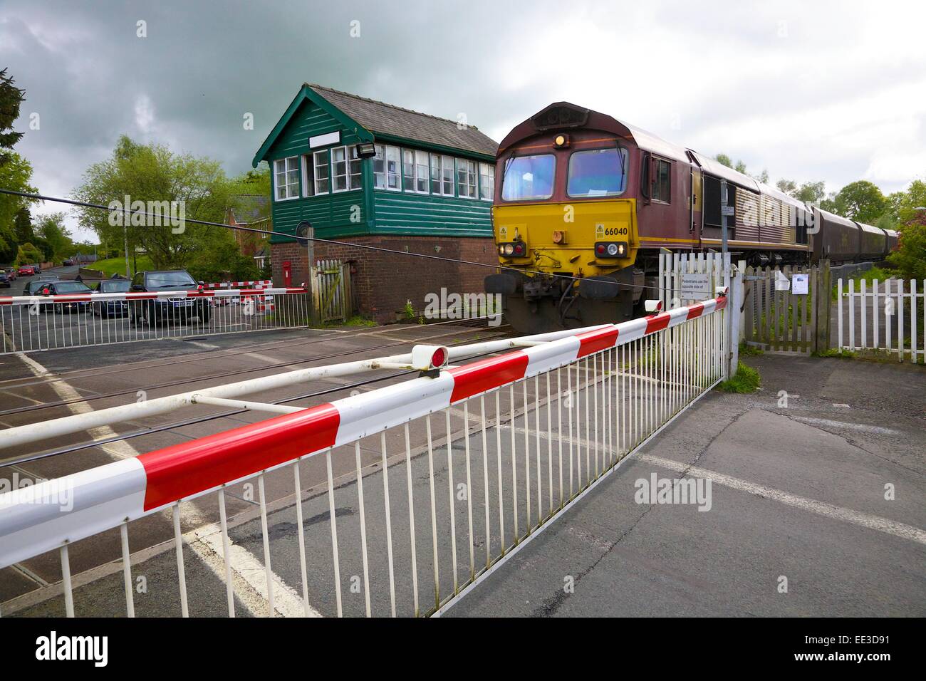 EWS train at level crossing Great Corby, Eden Valley, Cumbria, England, UK. Stock Photo
