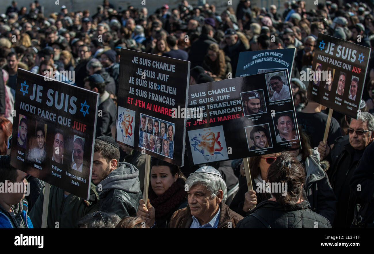 Jeruslaem, Israel. 13th Jan, 2015. People hold placards during a funeral ceremony for the four victims of Paris supermarket attack at Givat Shaul cemetery, on the outskirts of Jerusalem, on Jan. 13, 2015. Israeli leaders and multitude of mourners gathered Tuesday with the families of four Jewish victims of last week's terror attack on a Paris kosher supermarket for a solemn funeral ceremony at a Jerusalem cemetery. Yoav Hattab, Yohan Cohen, Philippe Braham and Francois-Michel Saada, were gunned down on Friday during a hostage attack in Paris.market in eastern Paris. Credit:  Xinhua/Alamy Live  Stock Photo