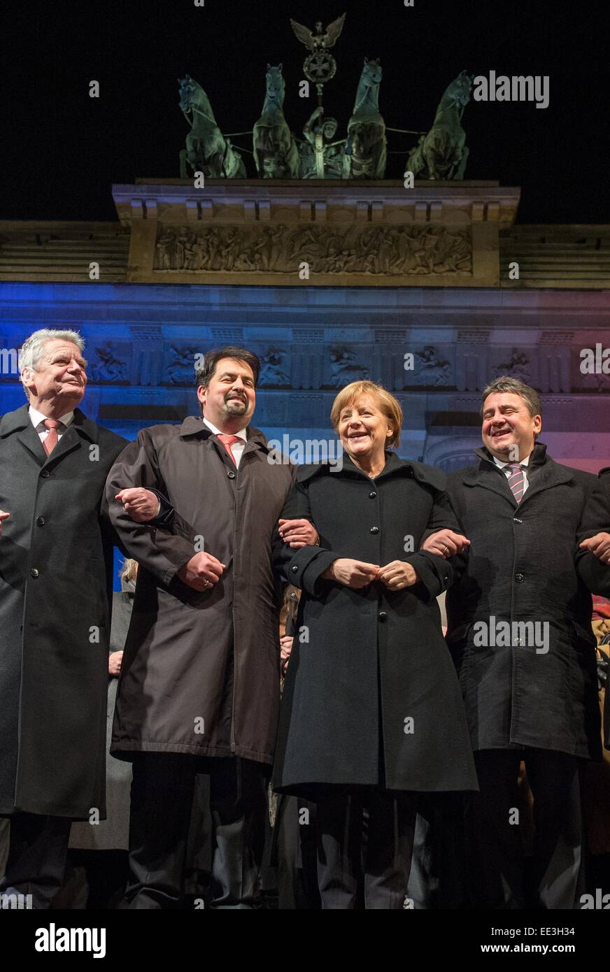 Berlin, Germany. 13th Jan, 2015. German President Joachim Gauck (L-R), chairman of the Central Committee of Muslims in Germany, Aiman Mazyek, Chancellor Angela Merkel, Minister of Economic Affairs Sigmar Gabirel, attend a vigil for the victims of the attacks in France at the Brandenburg Gate in Berlin, Germany, 13 January 2015. The Central Committee of Muslims and the Turkish community have invoked the slogan 'Stand together - Show face' for the rally against Islamist terror and for the peaceful co-existence of the religions. Photo: MAURIZIO GAMBARINI/dpa/Alamy Live News Stock Photo