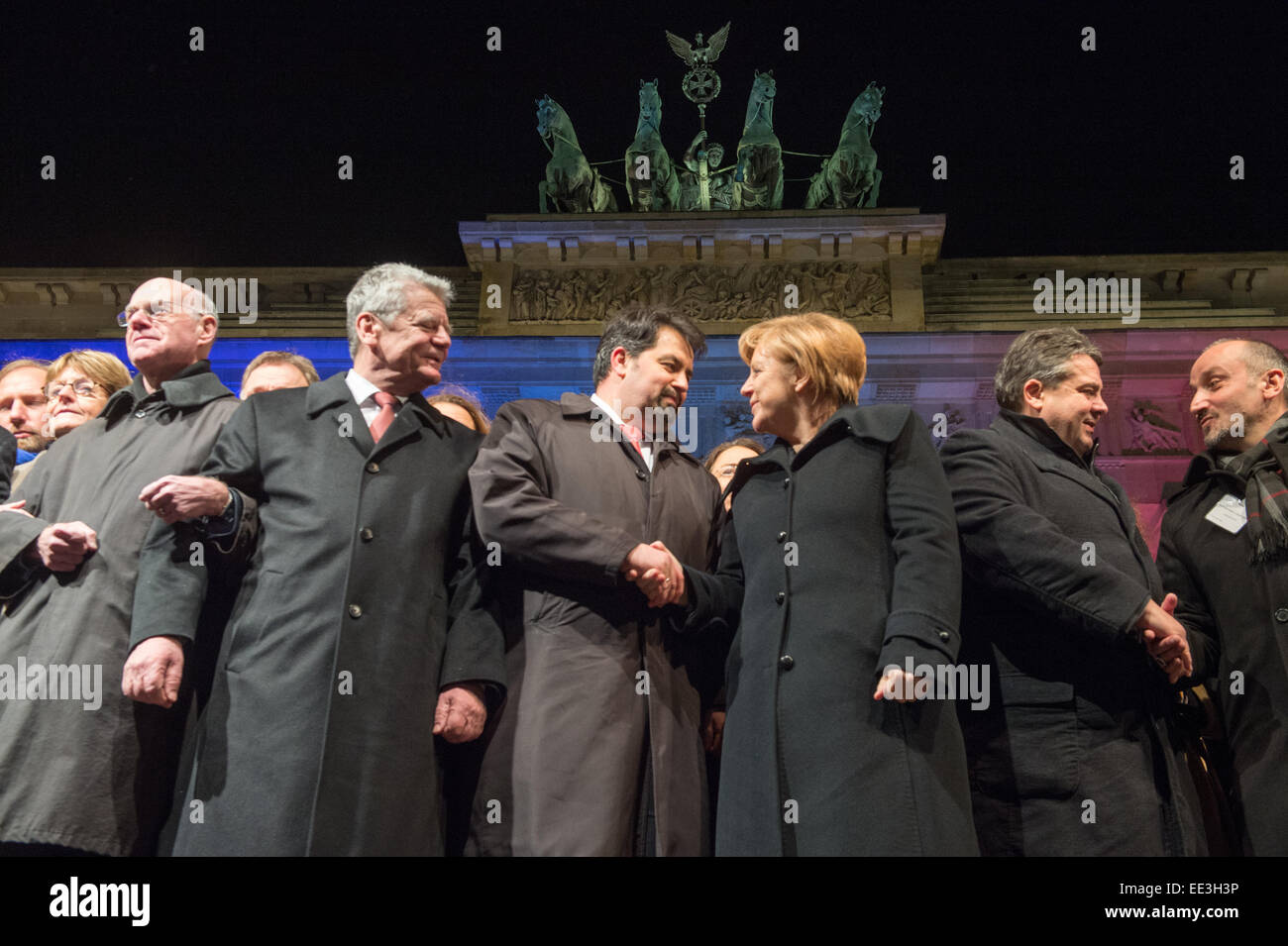 President of the Bundestag, Norbert Lammer (L-R), German President Joachim Gauck, chairman of the Central Committee of Muslims in Germany, Aiman Mazyek, Chancellor Angela Merkel, Minister of Economic Affairs Sigmar Gabirel, and the chairman of the Turkish Community in Berlin, Bekir Yilmaz, attend a vigil for the victims of the attacks in France at the Brandenburg Gate in Berlin, Germany, 13 January 2015. The Central Committee of Muslims and the Turkish community have invoked the slogan 'Stand together - Show face' for the rally against Islamist terror and for the peaceful co-existence of the Stock Photo