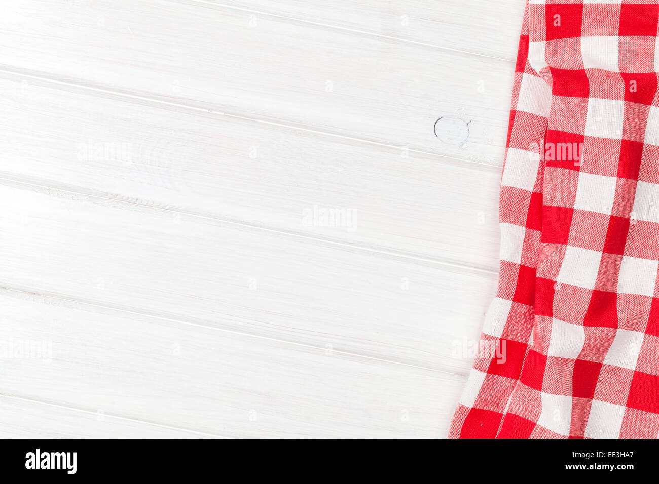 Red towel over wooden kitchen table. View from above with copy space Stock Photo