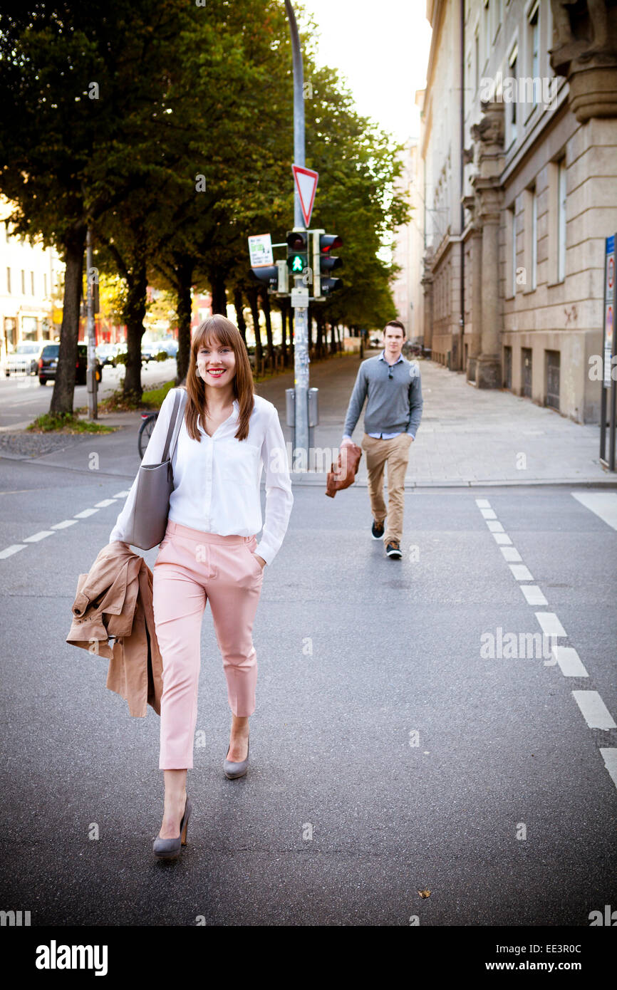 Young couple walking on city street, Old Town, Munich, Bavaria, Germany Stock Photo