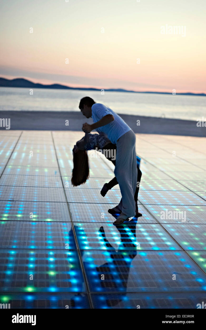Solar panels as a dance floor, sunset in background Stock Photo