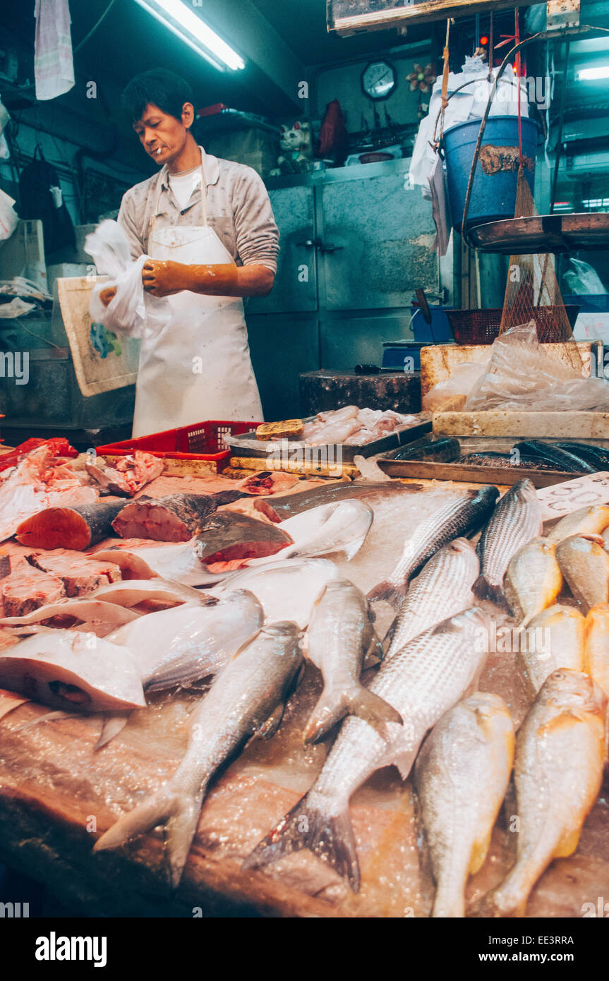 Asian fishmonger or fish seller in Hong Kong wet market. Stock Photo