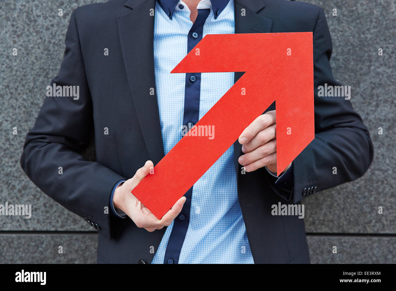 Hands of businessman holding big red arrow pointing up Stock Photo - Alamy