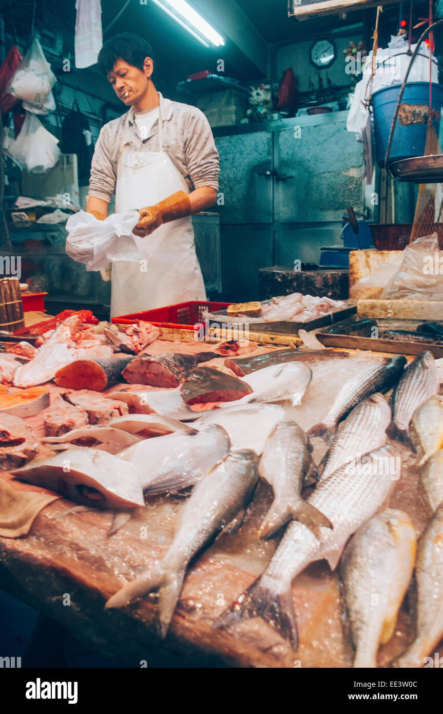 Asian fishmonger or fish seller in Hong Kong wet market. Stock Photo