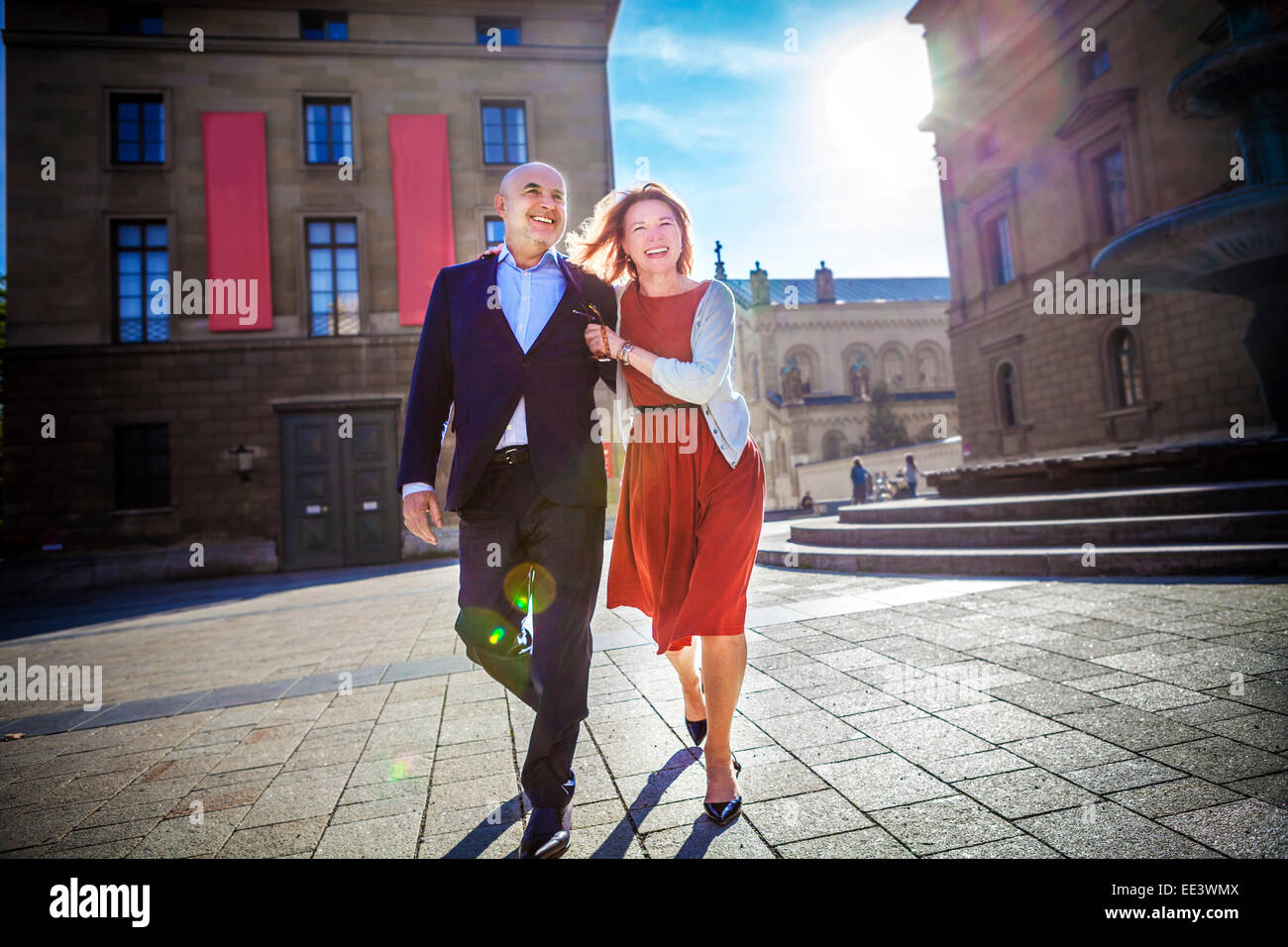 Senior couple walking over city square, Munich, Bavaria, Germany Stock Photo