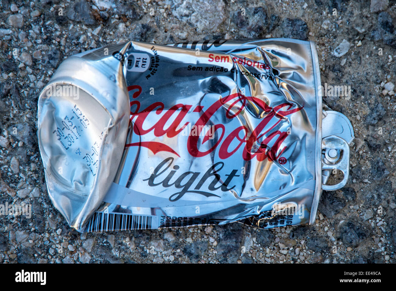 flat discarded tin of Coca Cola Light in the street. Stock Photo