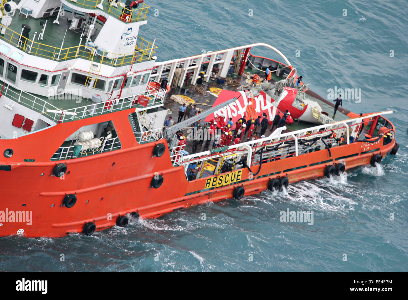 Offshore supply ship the Crest Onyx holds the tail section of Air Asia flight 8501 after recovering the piece from the sea floor January 12, 2015 in the Java Sea. Stock Photo