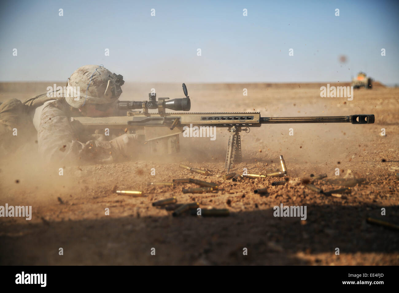 A US Marine special forces commando fires a .50 caliber Special Applications Scoped Rifle at a target 1,200 meters away January 6, 2015 in Camp Pendleton, California. Stock Photo