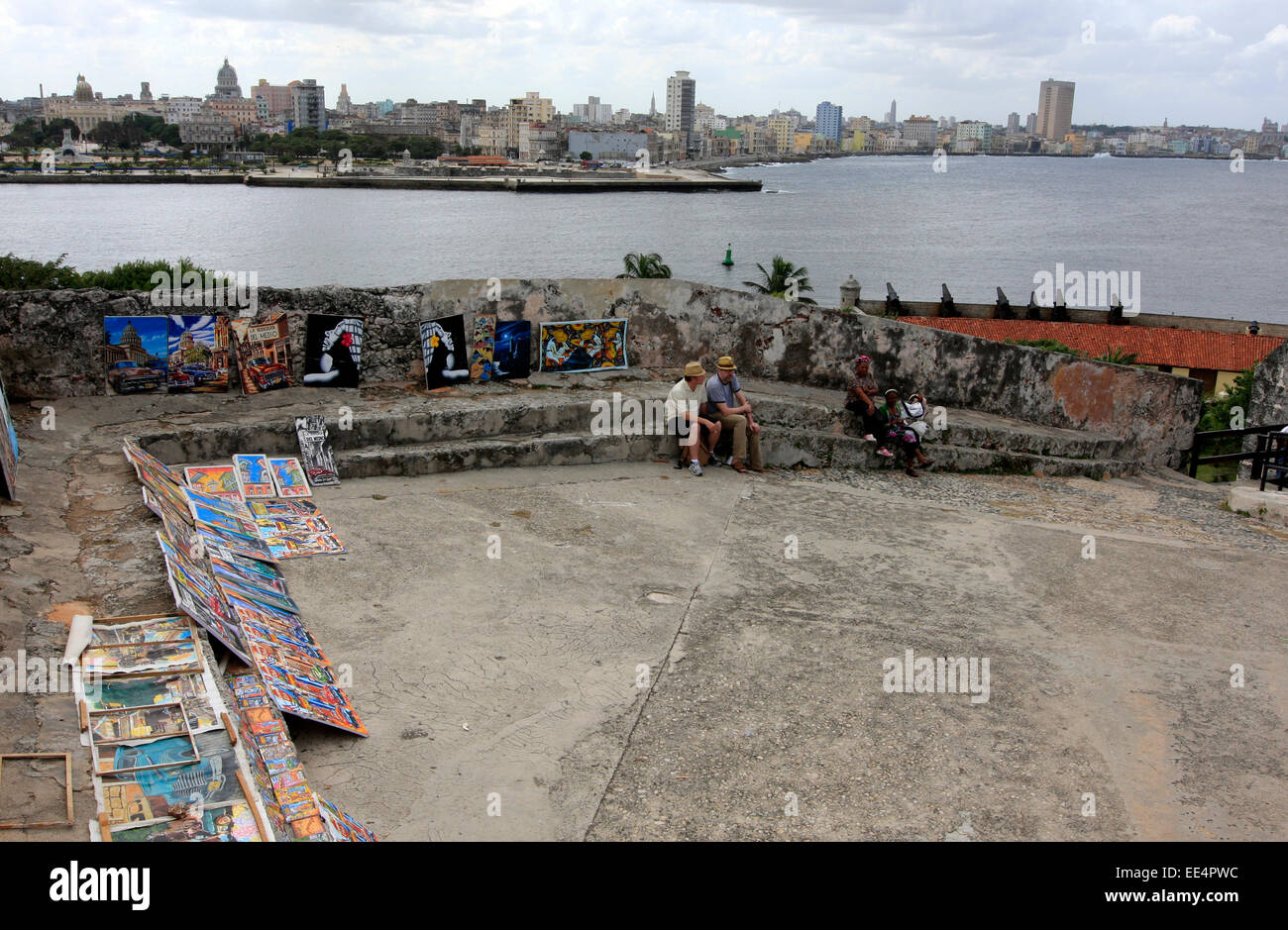 Selling pictures inside the old walls of the Morro Castle in Havana, Cuba with the Havana skyline in the background Stock Photo