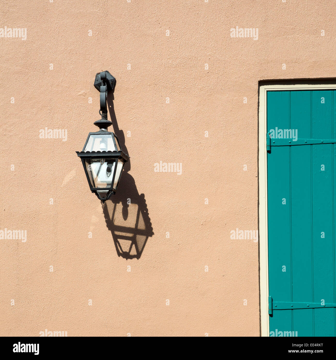 French Quarter, New Orleans, Louisiana.  Lamp and Shadow on Side of Creole Cottage. Stock Photo