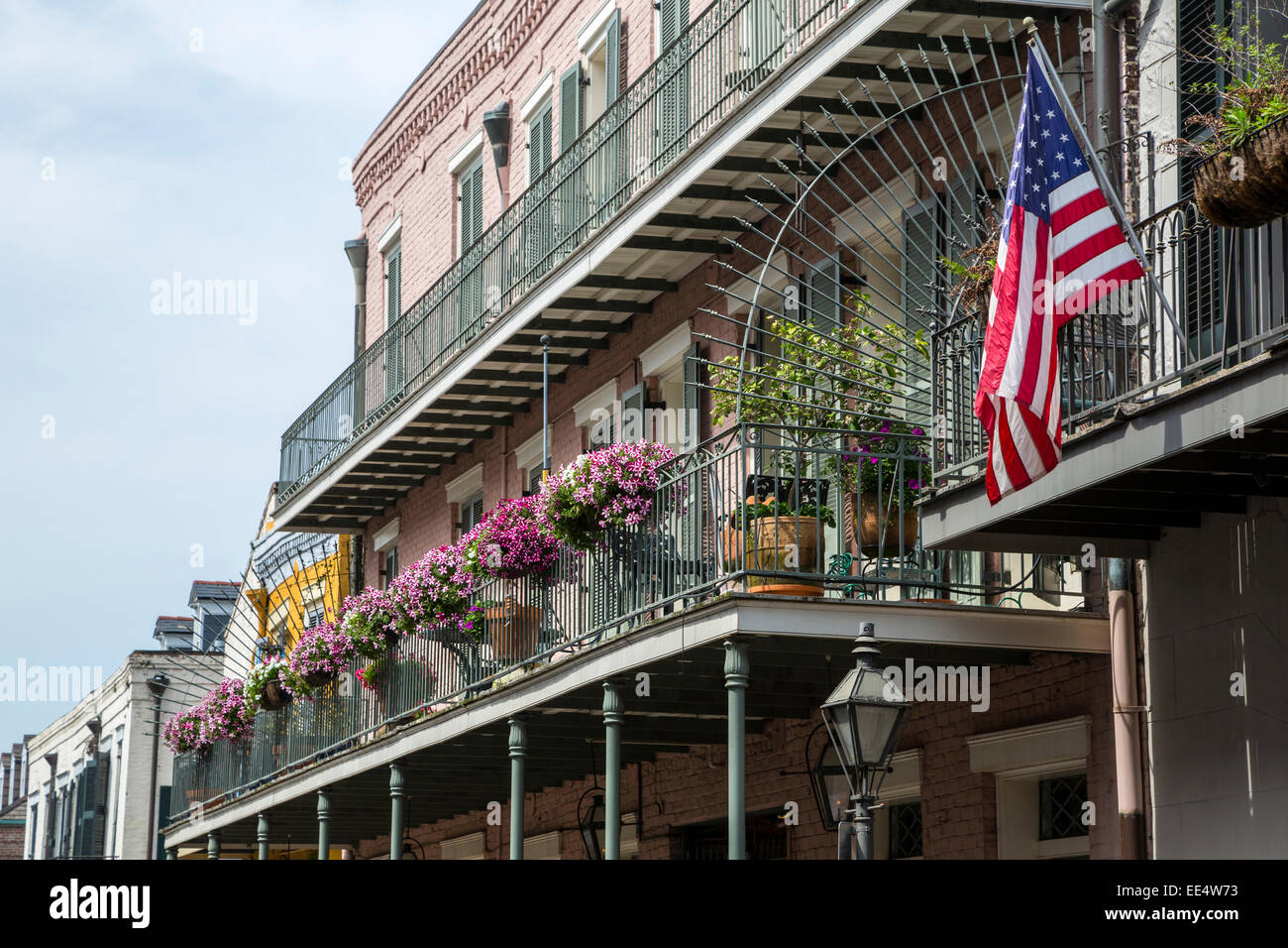 French Quarter New Orleans Louisiana Balcony With Flowers And Flag Stock Photo Alamy