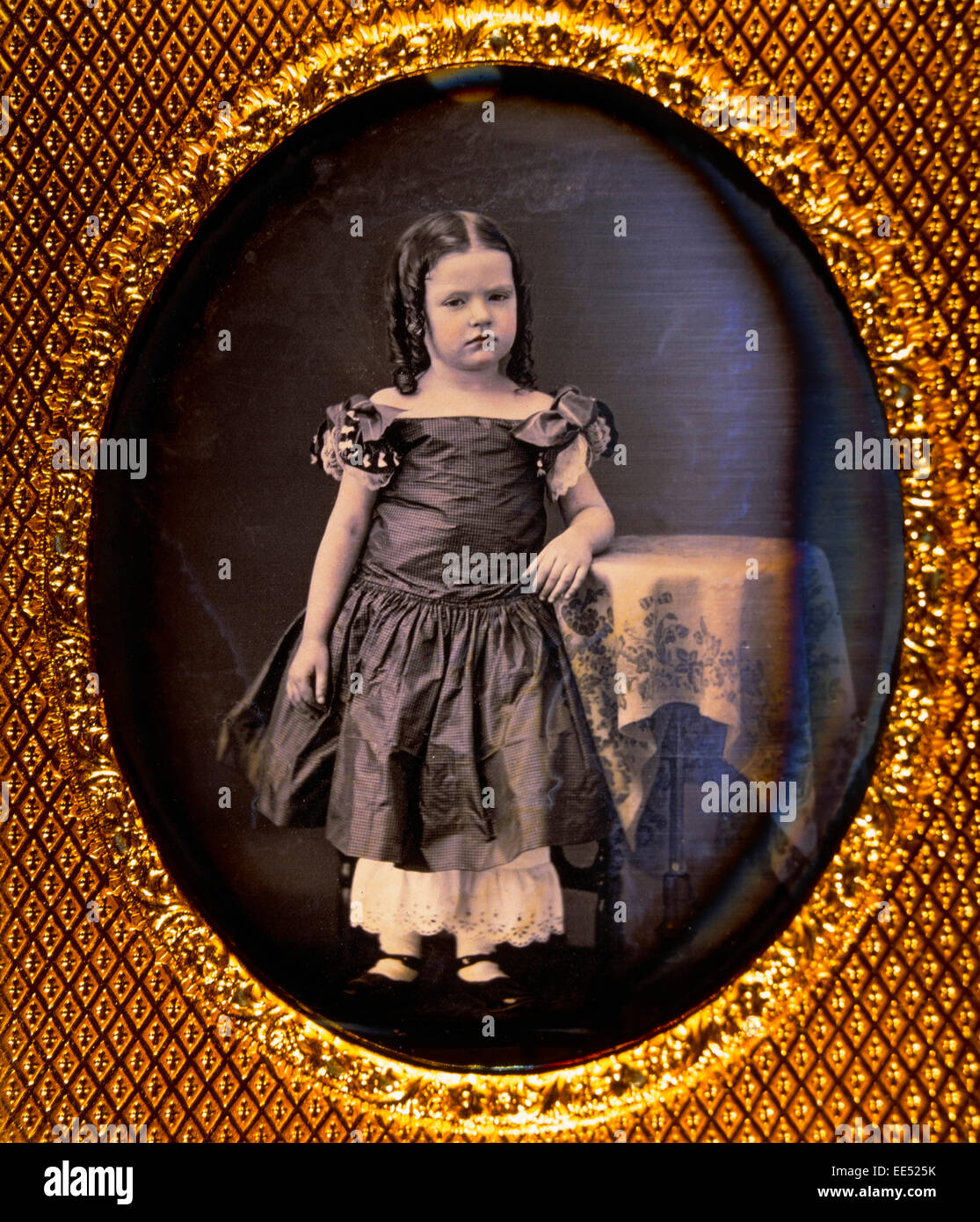 Young Girl Standing on Stool with Arm Resting on Table, Portrait, Daguerreotype, circa 1850's Stock Photo