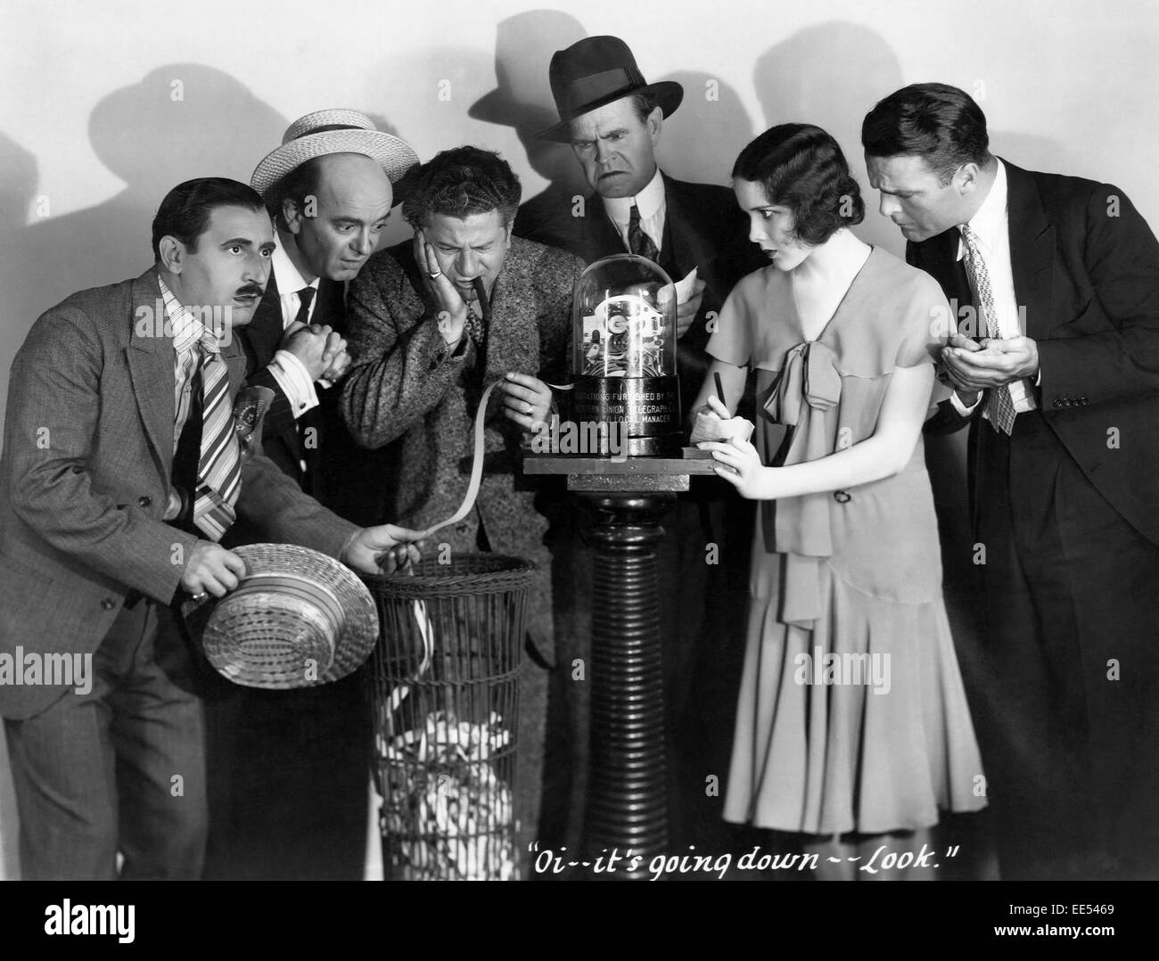 Harry Green, (holding ticker tape), Mary Brian, Neil Hamilton, on-set of the Film, 'The Kibitzer', 1930 Stock Photo
