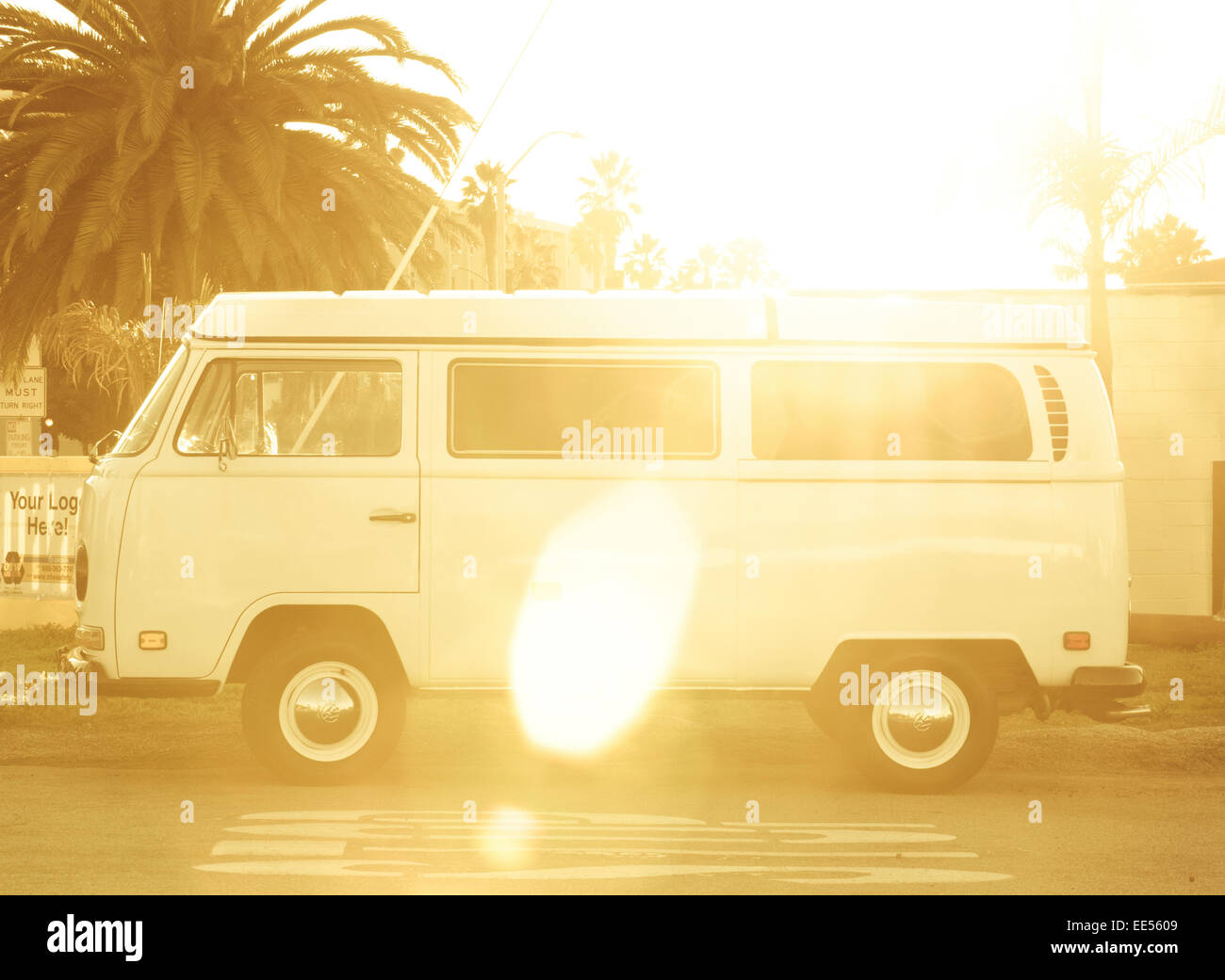 A vintage white westfalia parked on the side of the road in front of a ...