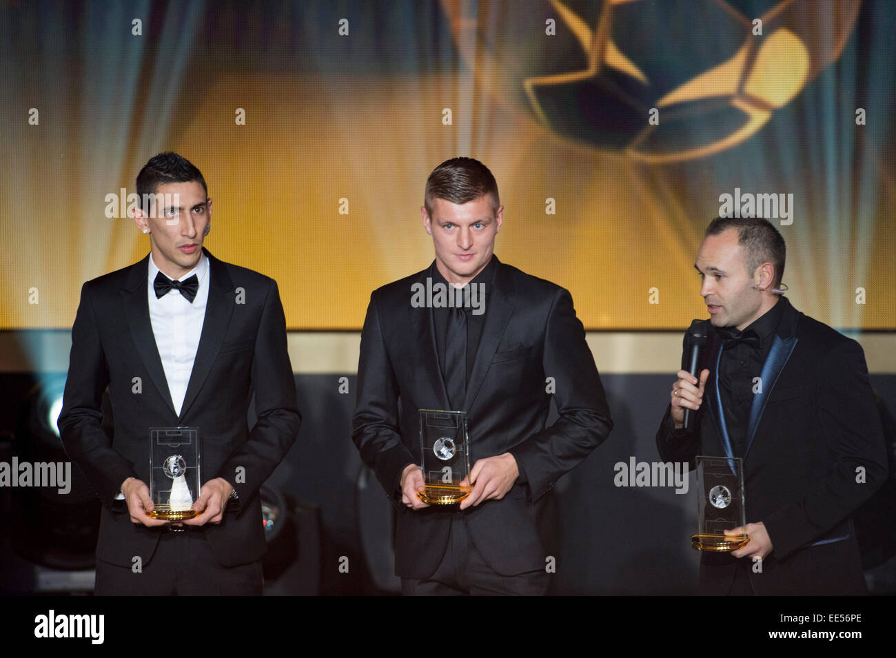 Zurich, Switzerland. 12th Jan, 2015. (L-R) Angel Di Maria, Toni Kroos, Andres Iniesta Football/Soccer : Andres Iniesta speaks after receiving the FIFA/FIFPro World XI 2014 trophy during the FIFA Ballon d'Or 2014 Gala at Kongresshaus in Zurich, Switzerland . © Maurizio Borsari/AFLO/Alamy Live News Stock Photo