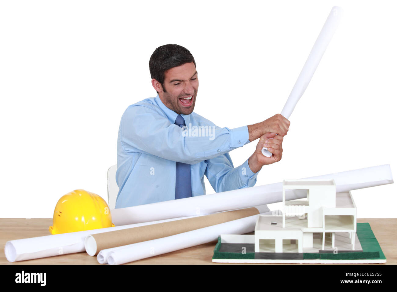 Man about to destroy a building model Stock Photo