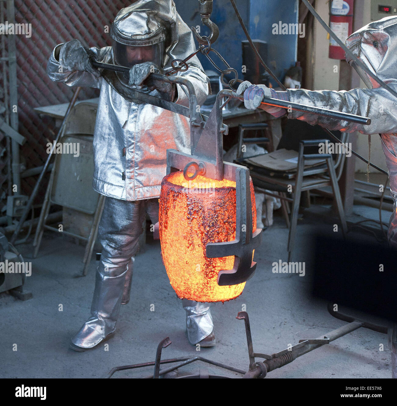 Burbank, California, USA. 13th Jan, 2015. American Fine Arts Foundry workers secure a red hot casting bucket before pouring molten bronze into molds for the 2015 21st Annual SAG Awards.The bronze molded awards for the 2015 Annual Screen Actor's Guild Awards were cast at the American Fine Arts Foundry in Burbank on Tuesday morning. © David Bro/ZUMA Wire/Alamy Live News Stock Photo