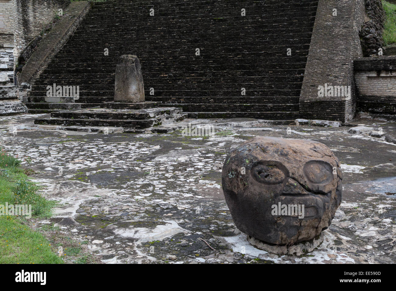 Stone head carving &alter at the Great Pyramid of Cholula or Tlachihualtepetl, a prehispanic archaeological site in Puebla Mexico Stock Photo