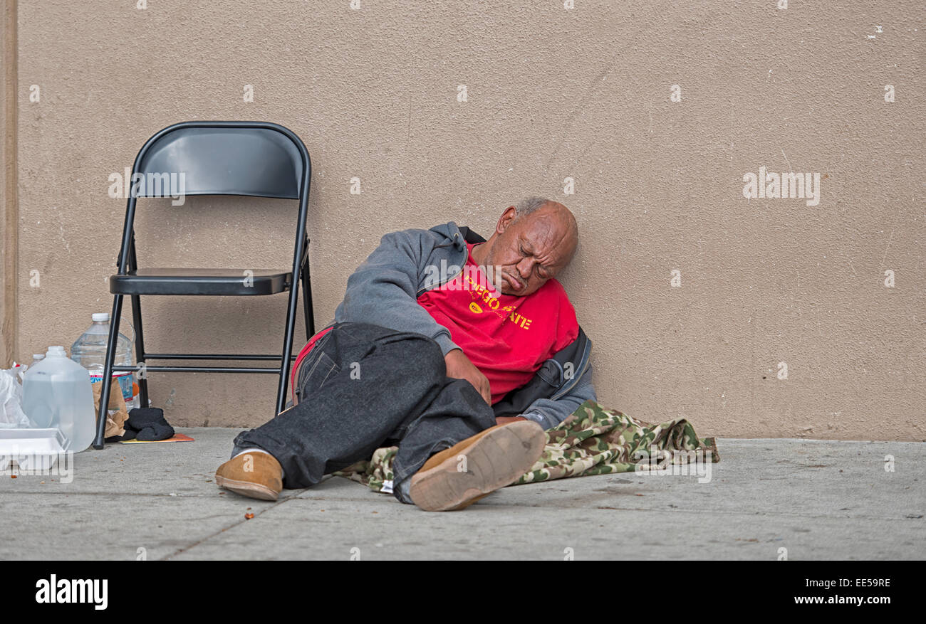 Man Sitting On Sidewalk Sleeping Next To Folding Chair East Village San Diego California Usa Stock Photo Alamy