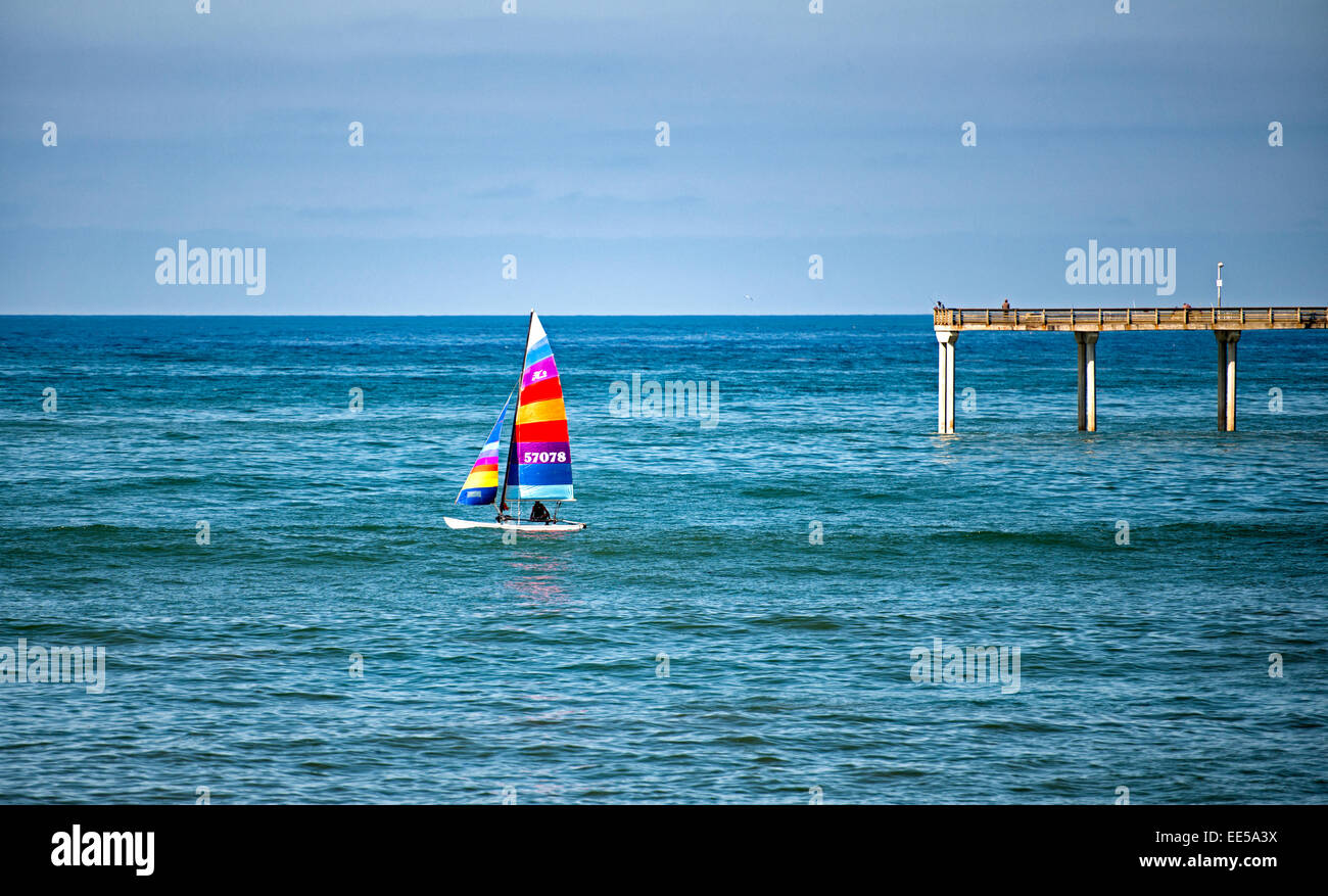 Hobie Cat (catamaran) Sailing Past Ocean Beach Pier, Ocean Beach, San Diego, California USA Stock Photo