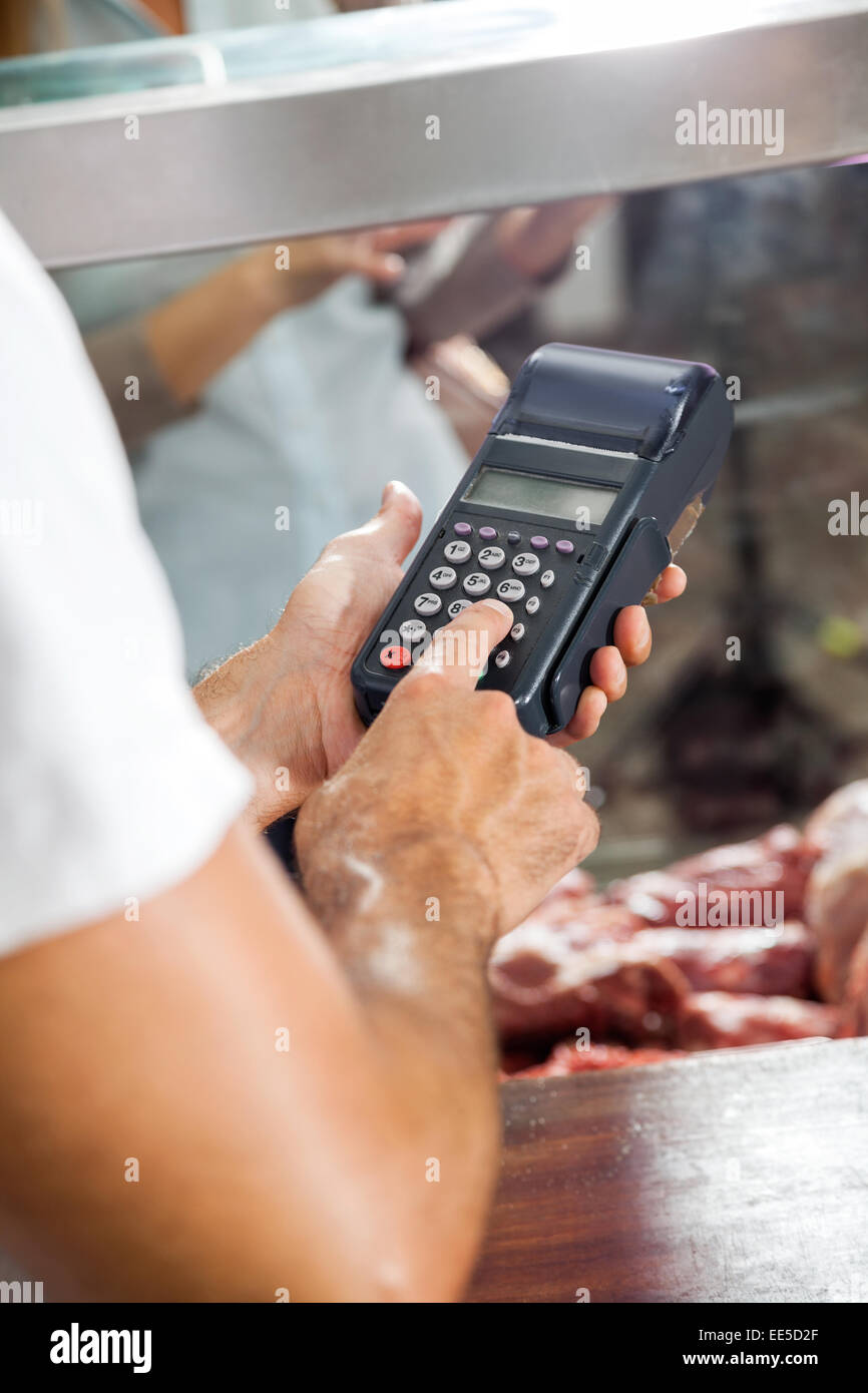 Butcher Using Electronic Card Machine In Shop Stock Photo Alamy