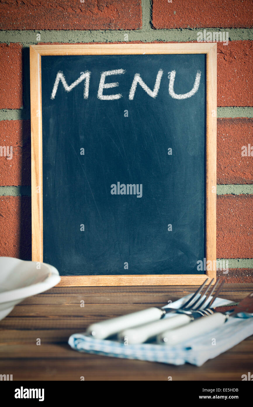 the menu blackboard before brick wall Stock Photo