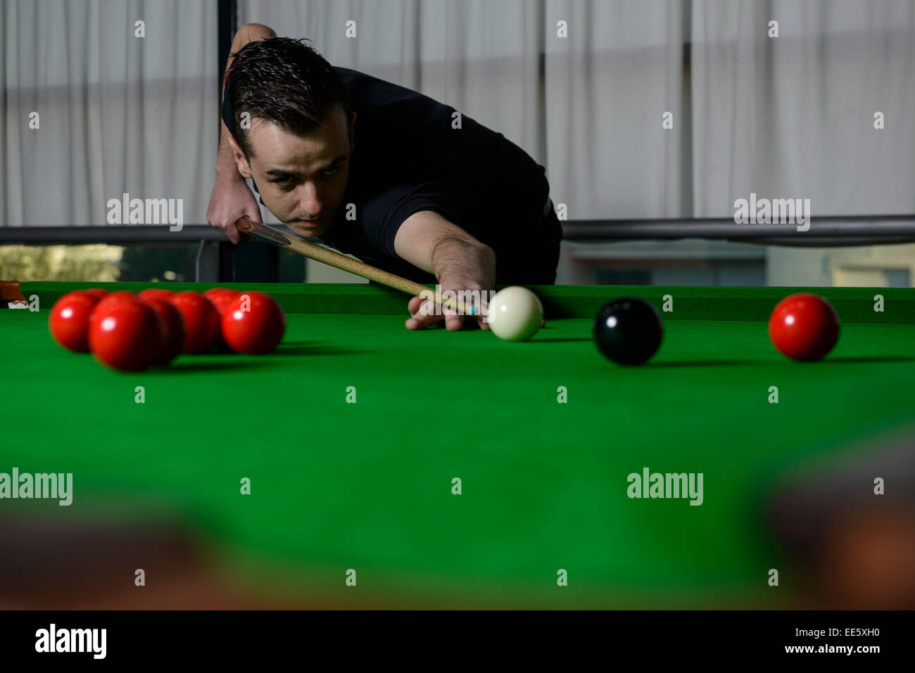 Young man playing snooker Stock Photo