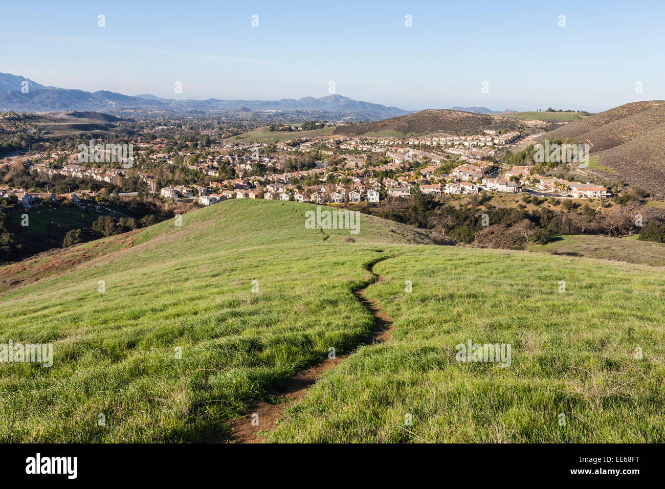 Suburban meadow hiking trail leading to upscale modern homes near Los Angeles in Thousand Oaks, California. Stock Photo