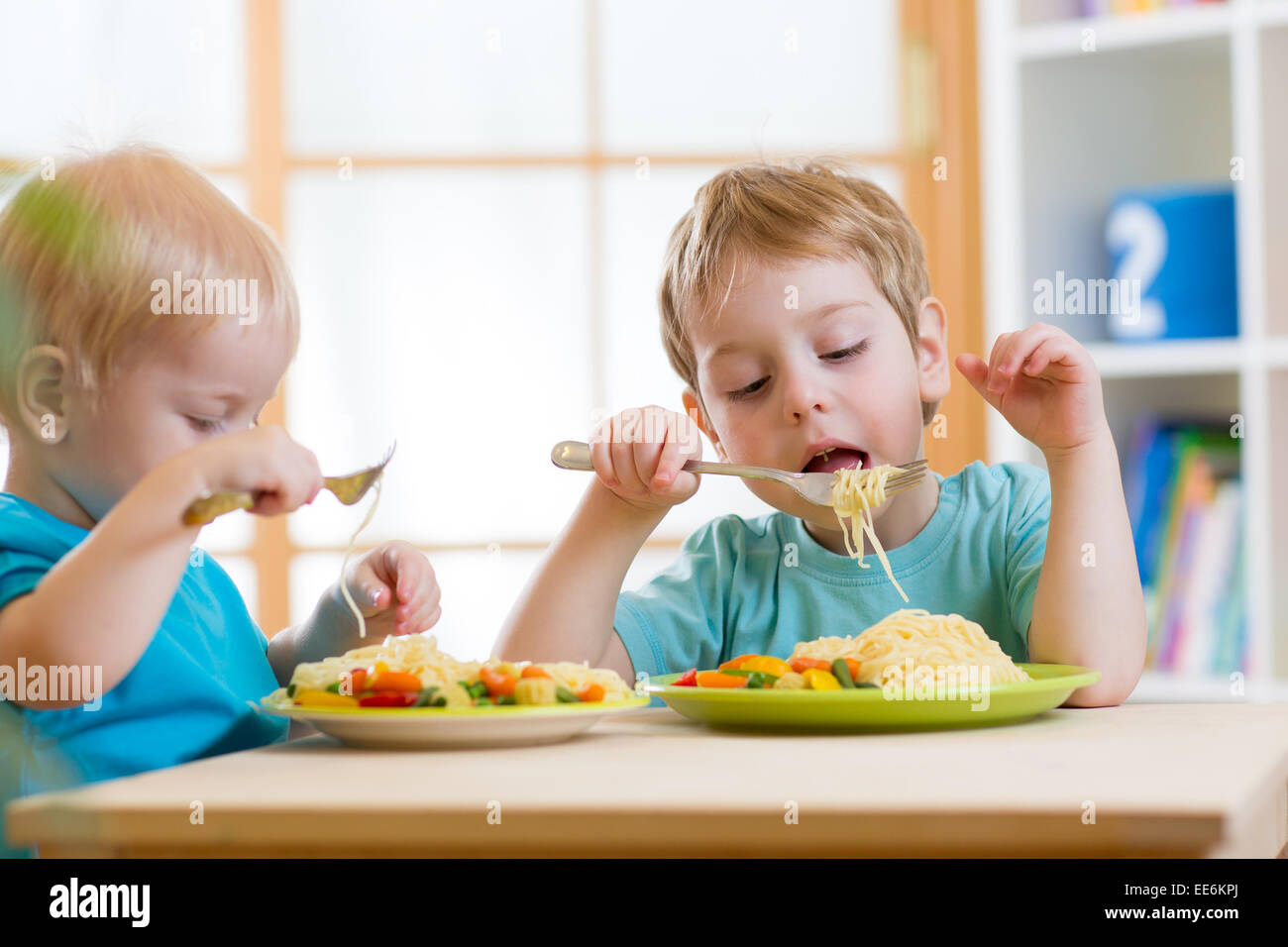 kids eating healthy food in kindergarten or nursery Stock Photo