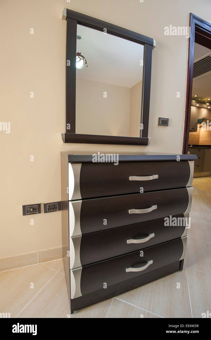 Set Of Drawers And Wall Mirror Furniture In Luxury Apartment Stock