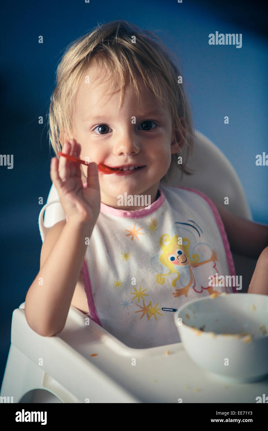 Little girl eating baby food Stock Photo Alamy