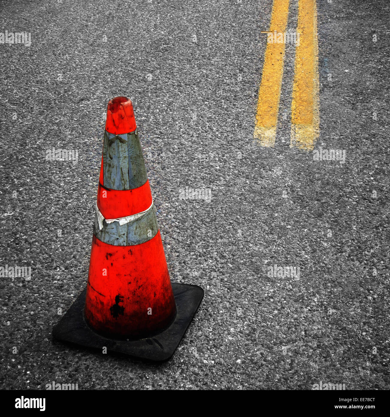 Detail of Construction Cone yellow street lines suggesting repair Stock Photo