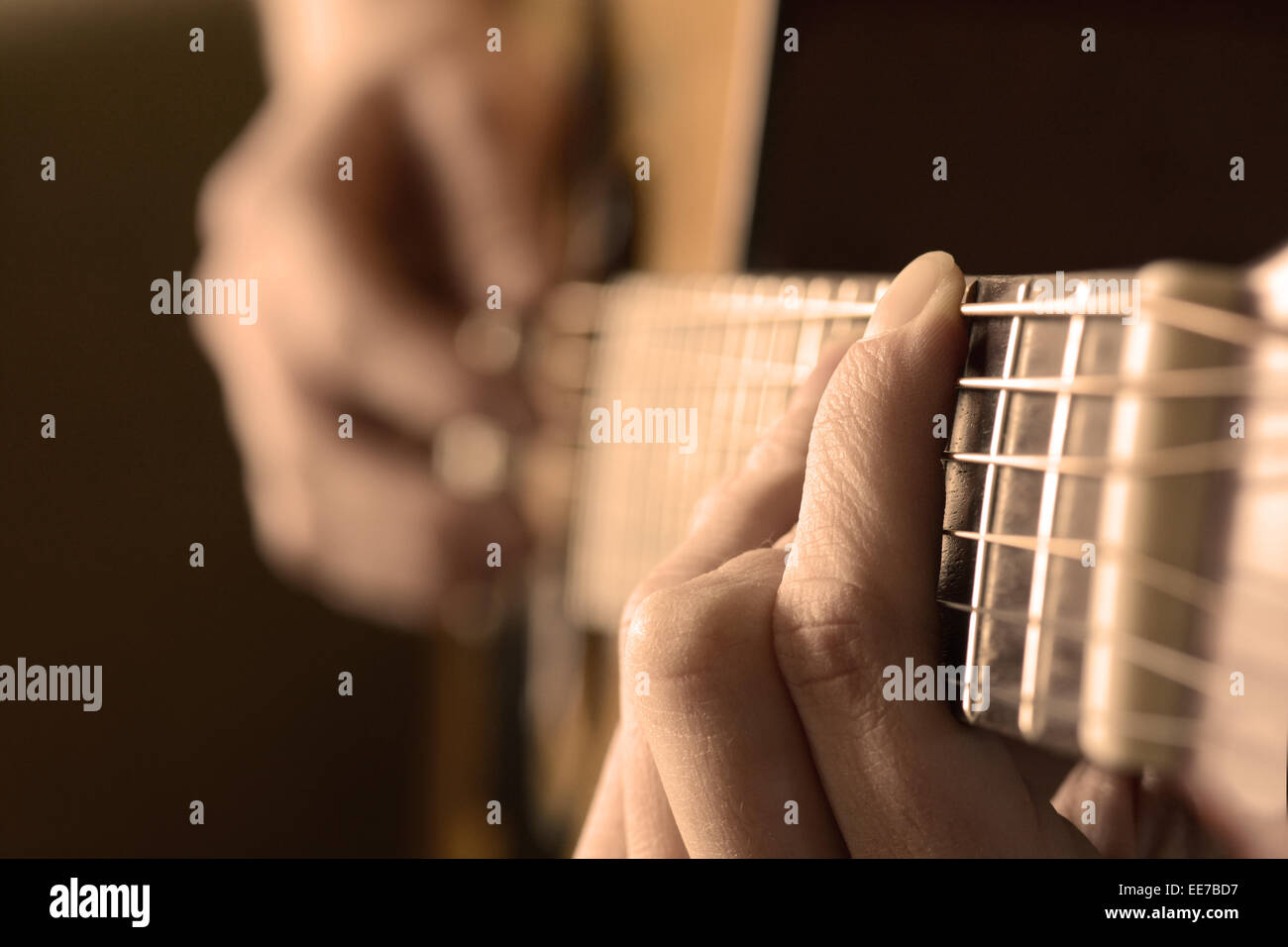 Playing guitar strings and frets for making music Stock Photo