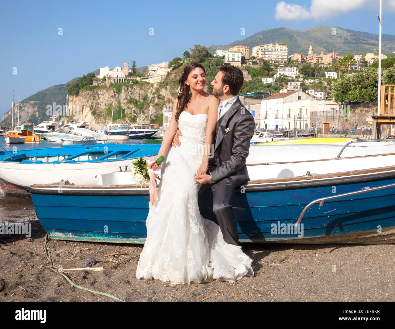 Married couple in day of their wedding at the beach in Sorrento coast. Stock Photo