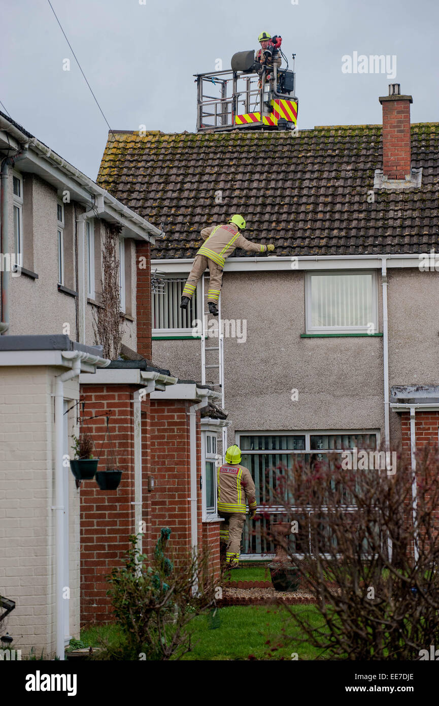 Haverfordwest, UK Wednesday 14 January 2015  Firemen attend to a damaged house   Two people were taken to hospital after a mini-tornado struck a row of houses in Haverfordwest, Pembrokeshire Stock Photo