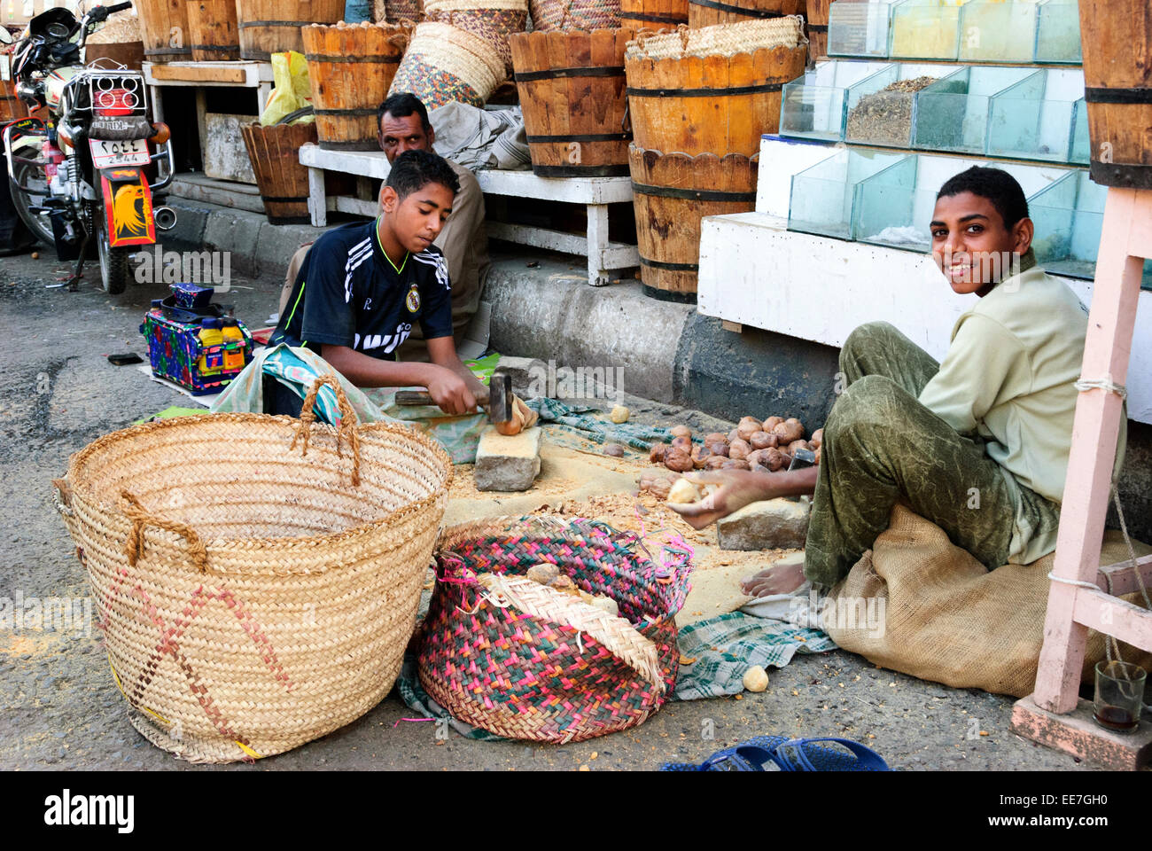 Egyptian boys crushing spices - Aswan, Upper Egypt Stock Photo