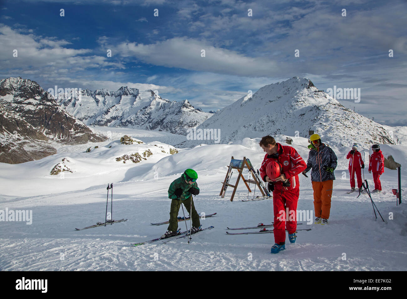 Swiss ski instructors gathering on top of ski slope near the Aletsch Glacier in winter, Riederalp, Wallis / Valais, Switzerland Stock Photo