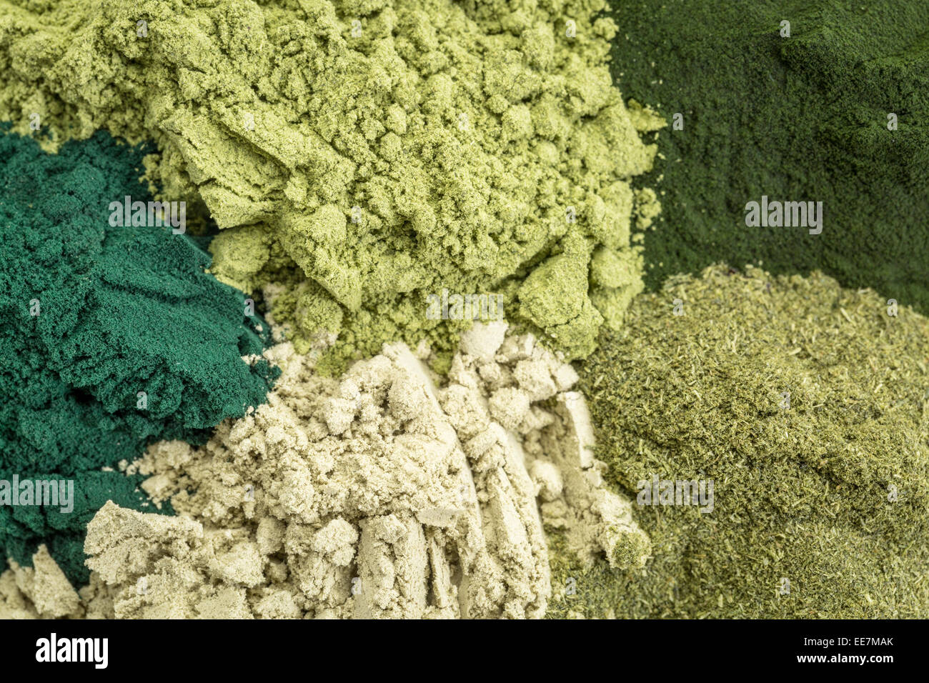 background of five healthy green dietary supplement powders (spirulina