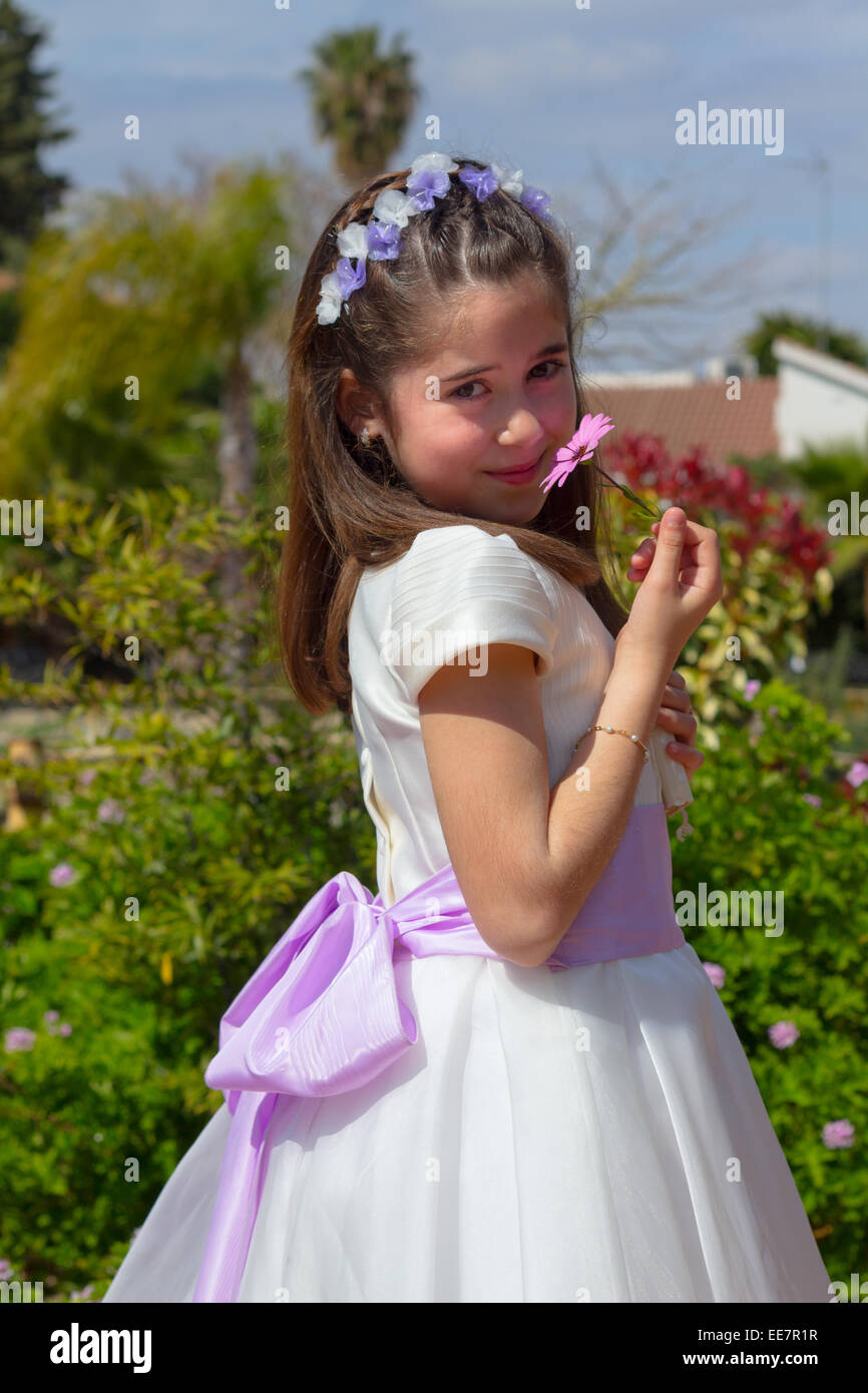 A young girl smiling and celebrating her First Holy Communion Stock Photo